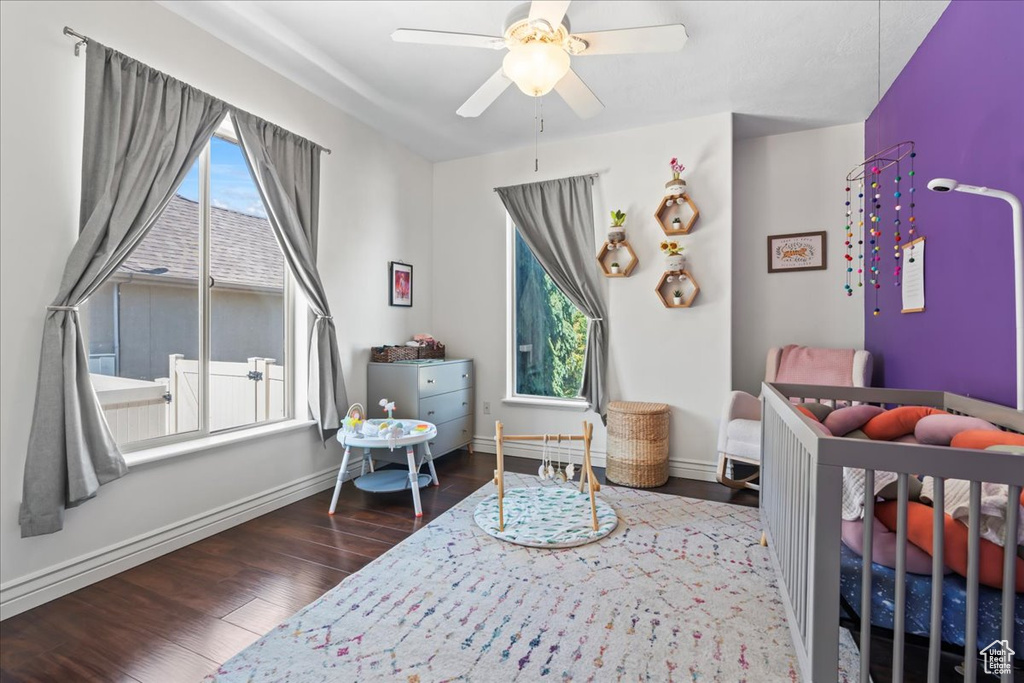 Bedroom with wood finished floors, baseboards, and ceiling fan