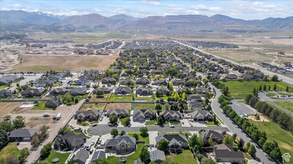 Aerial view of property\'s location with a mountainous background and nearby suburban area