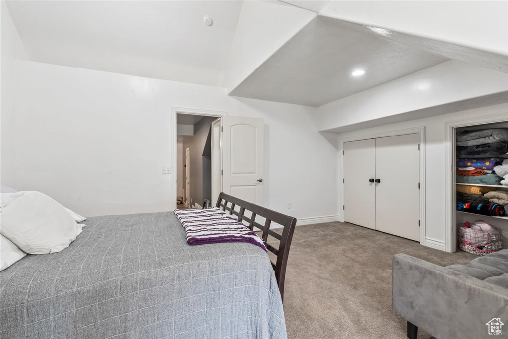 Bedroom featuring carpet and baseboards