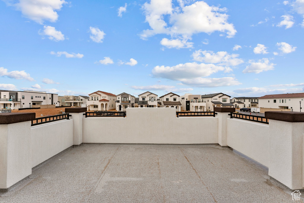 View of patio with a residential view and a balcony