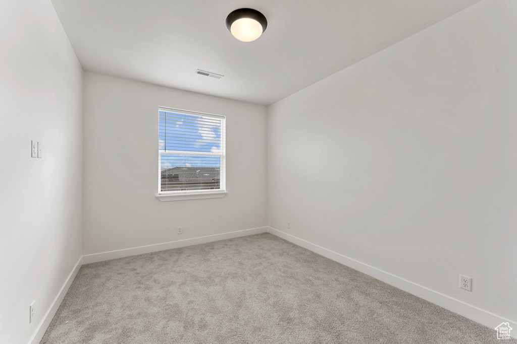 Unfurnished room with carpet floors and baseboards