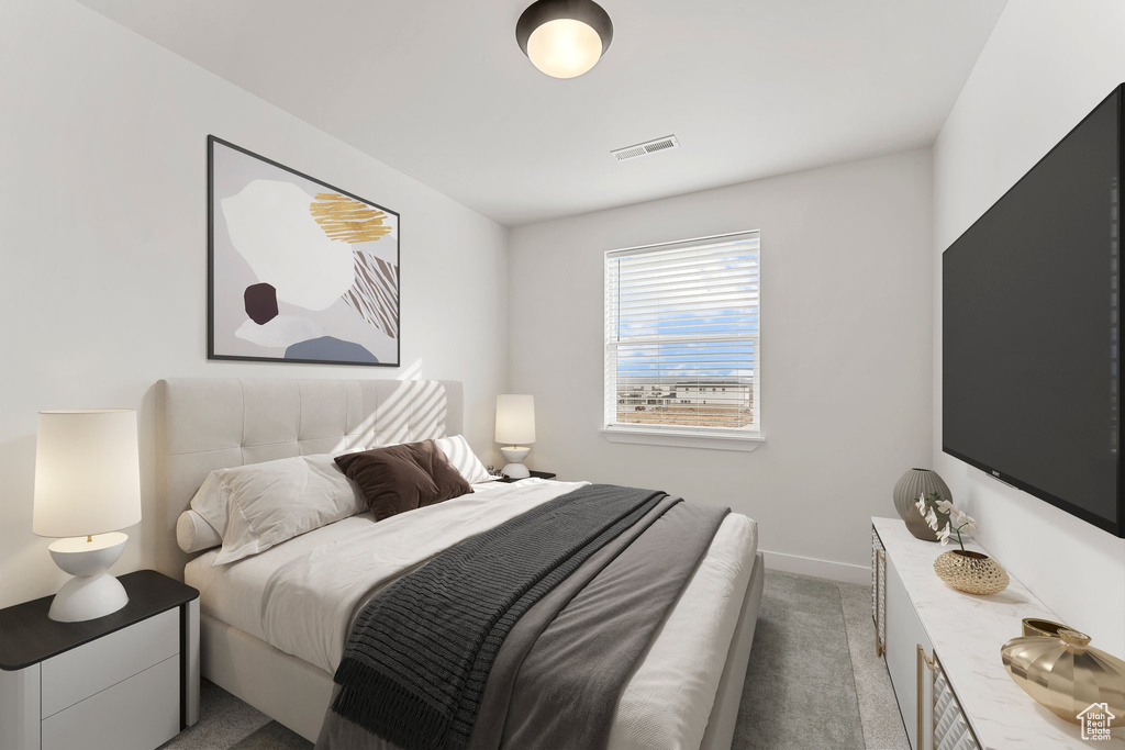 Bedroom featuring light colored carpet and baseboards