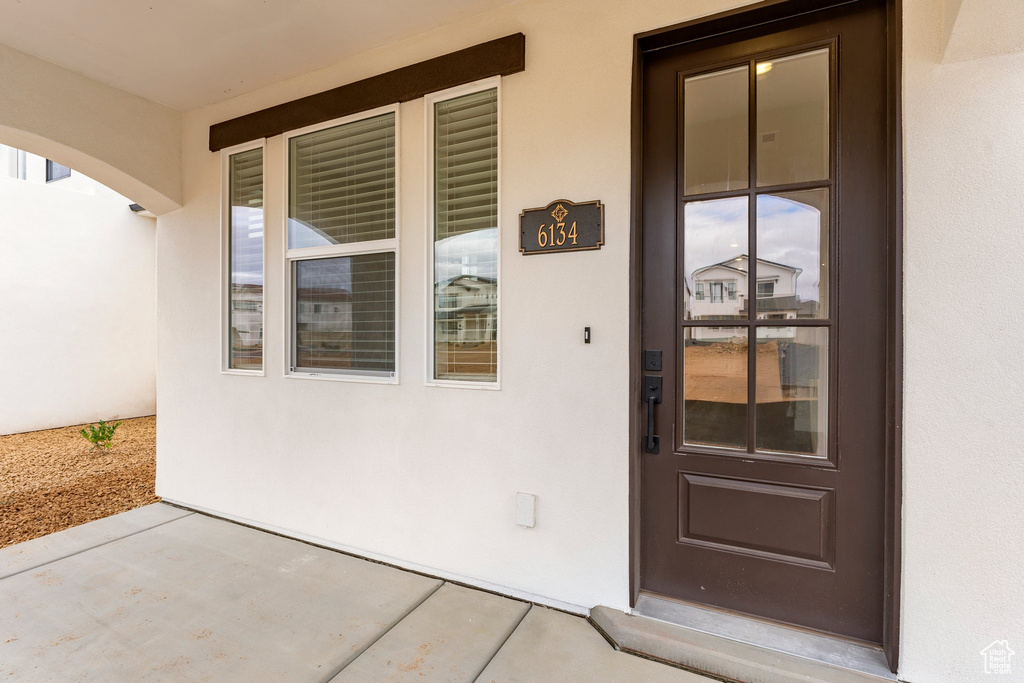 View of exterior entry with stucco siding