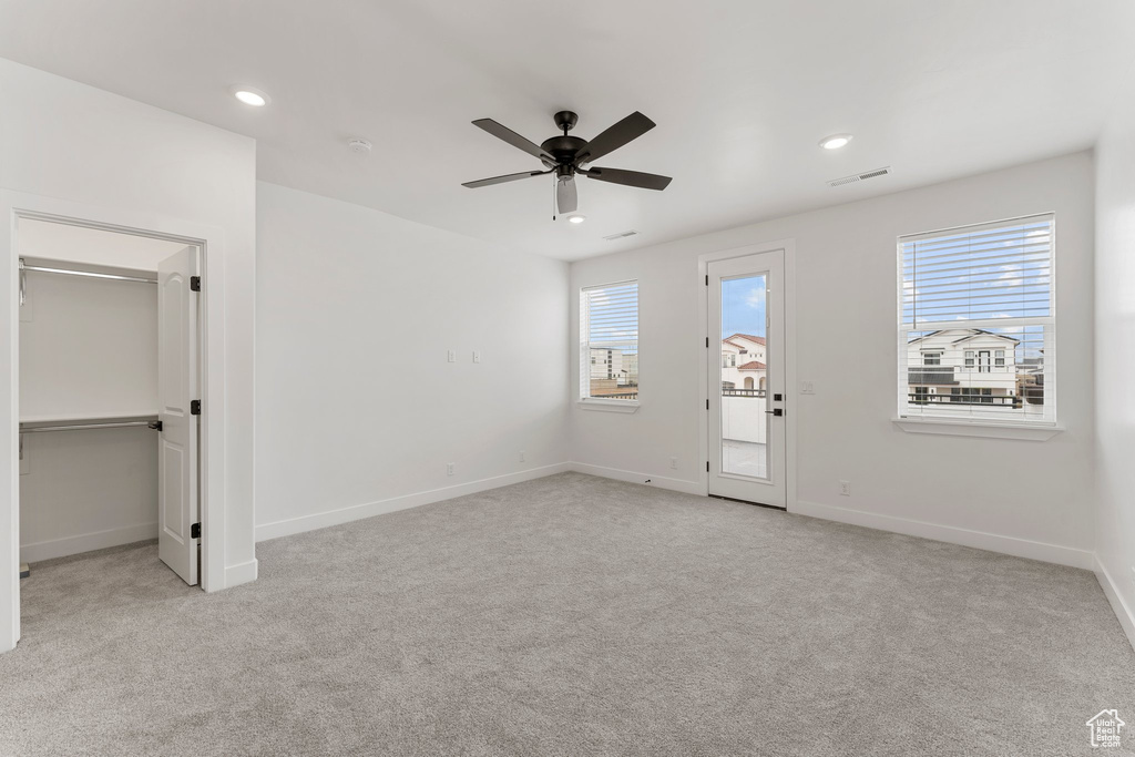 Unfurnished bedroom with carpet floors, multiple windows, baseboards, and recessed lighting