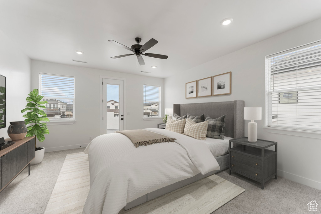 Bedroom featuring multiple windows, light carpet, baseboards, and recessed lighting