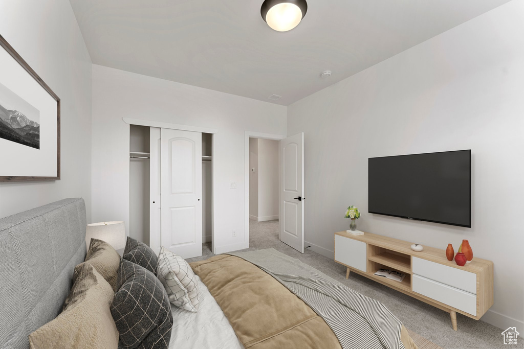 Bedroom featuring carpet, baseboards, and a closet