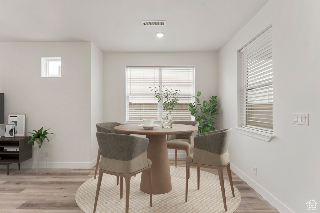 Dining space featuring baseboards, light wood-style floors, and recessed lighting