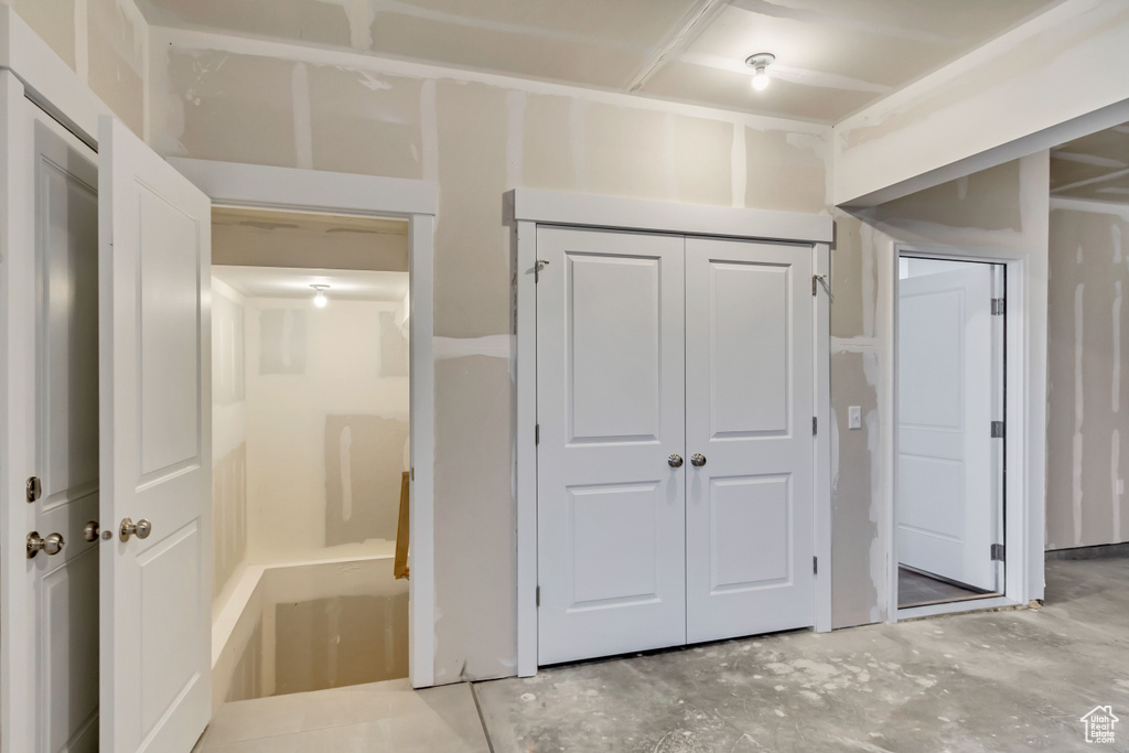 Unfurnished bedroom featuring a closet and unfinished concrete floors