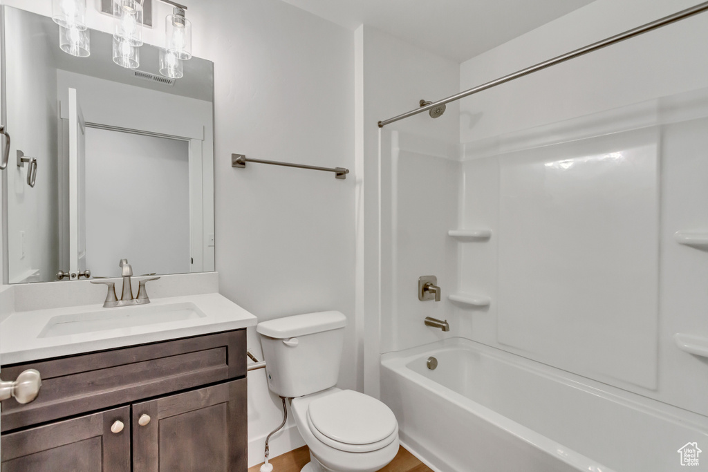 Full bath with vanity, toilet, and shower / bathtub combination