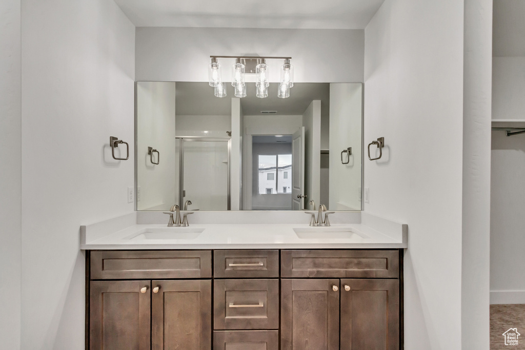 Bathroom with double vanity and a stall shower