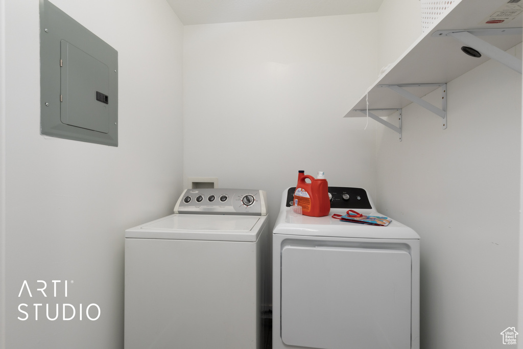 Washroom featuring electric panel and independent washer and dryer