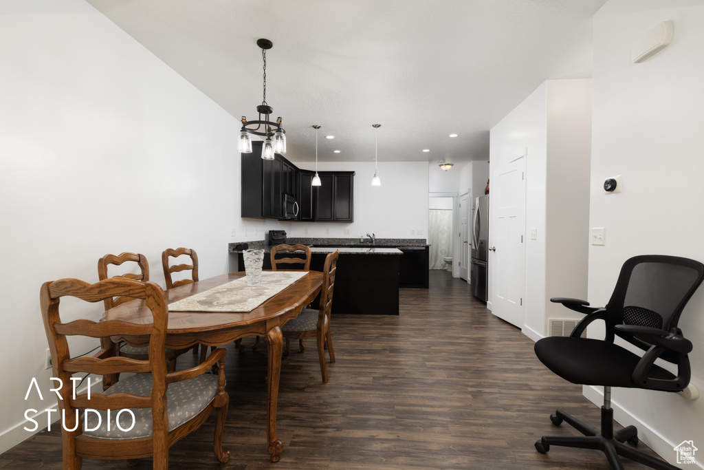 Dining area featuring recessed lighting, dark wood-style floors, and baseboards