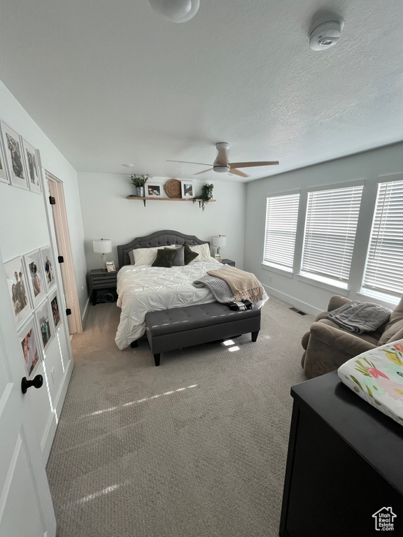 Bedroom featuring carpet floors, baseboards, and ceiling fan