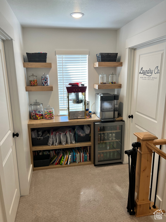 Sitting room with beverage cooler and carpet floors