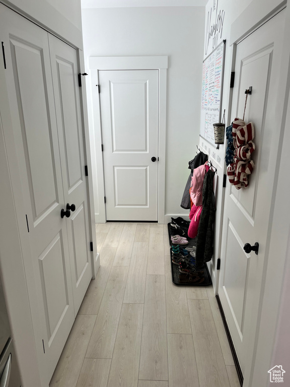 Hallway with light wood-style floors
