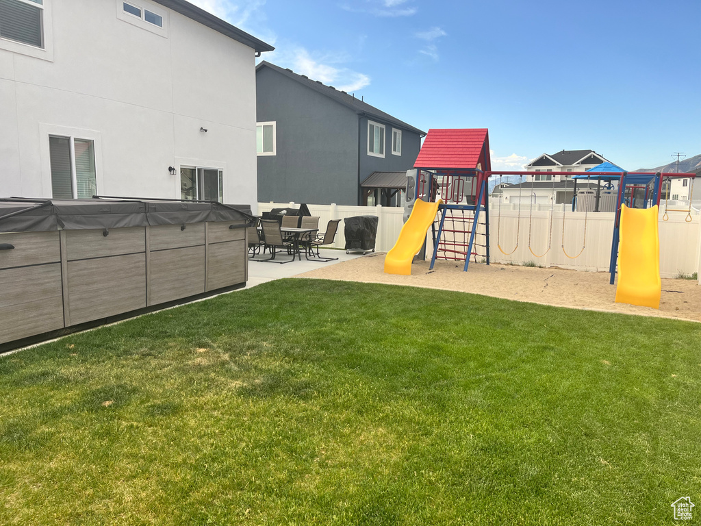 View of yard featuring a playground and a patio area