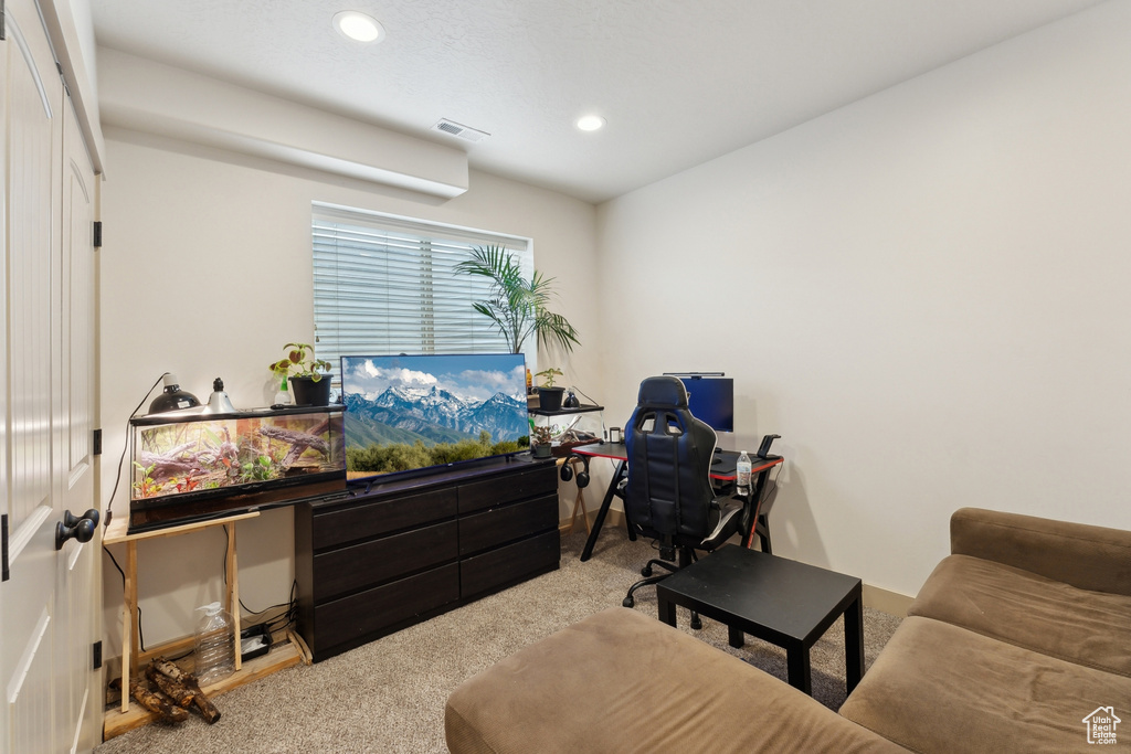 Carpeted home office with recessed lighting