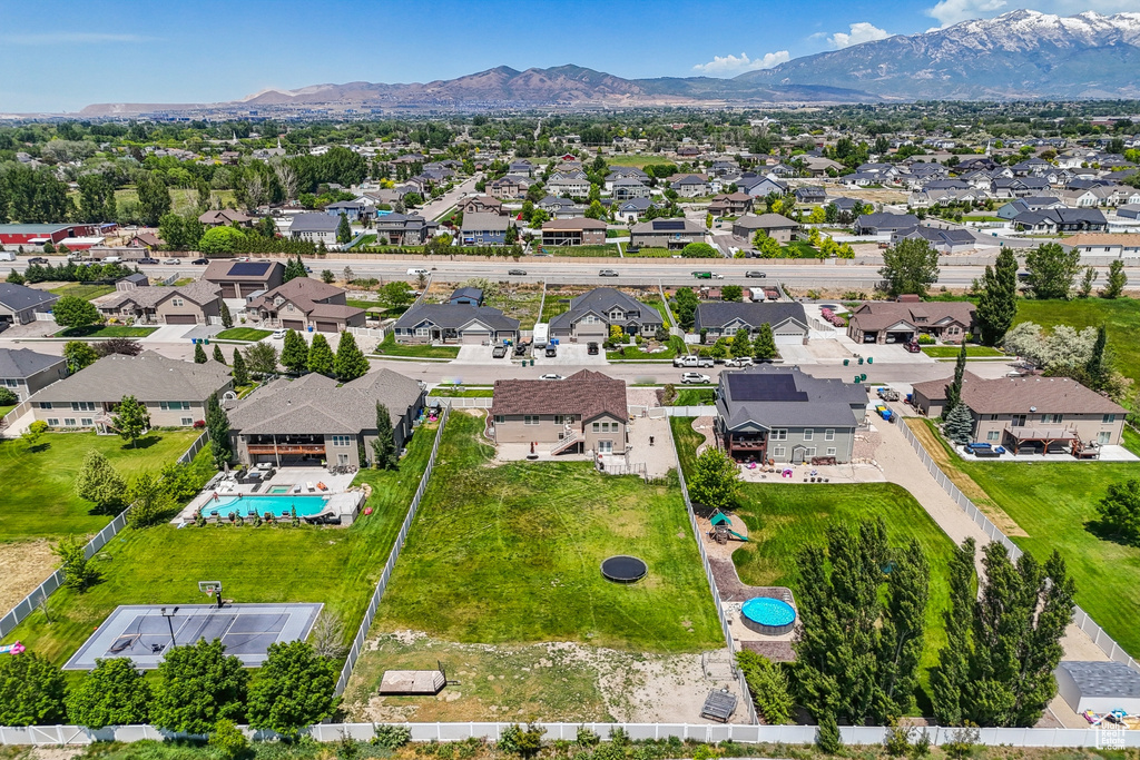 Aerial view of residential area with a pool and a mountain backdrop