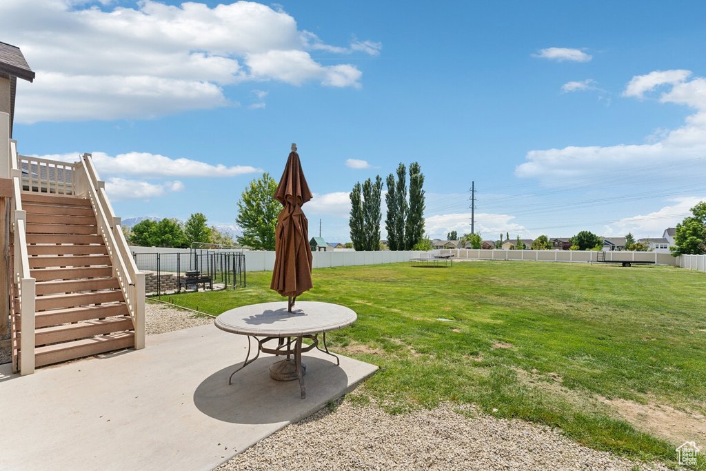 View of yard with a patio area and stairway