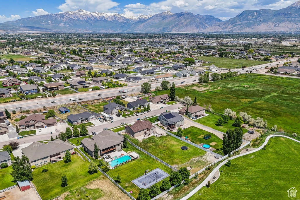 Aerial view of property's location featuring a mountain backdrop and nearby suburban area