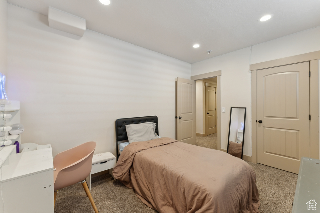 Bedroom with light colored carpet and recessed lighting