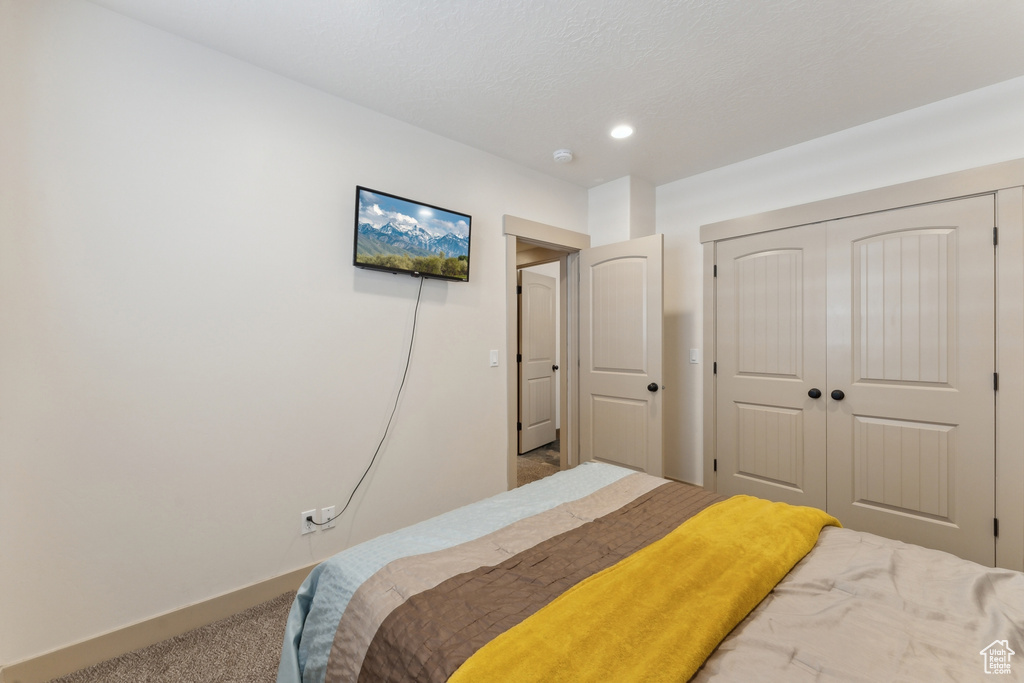 Bedroom with carpet floors, a closet, and recessed lighting