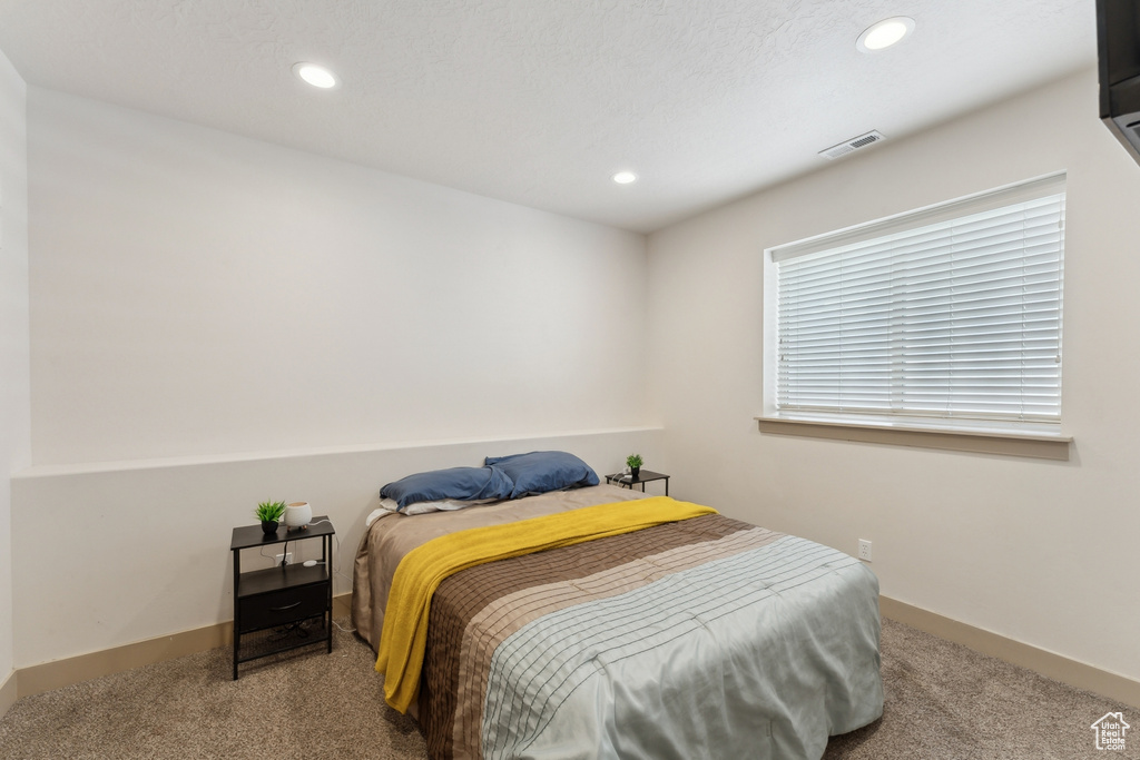 Carpeted bedroom with recessed lighting and baseboards