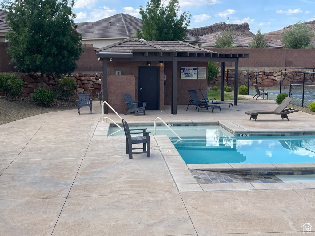 Community pool with a mountain view and a patio area