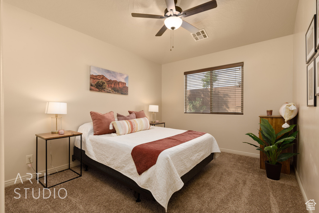 Bedroom featuring carpet floors, baseboards, and a ceiling fan