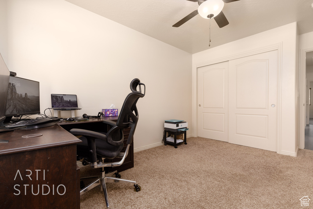 Carpeted home office with ceiling fan