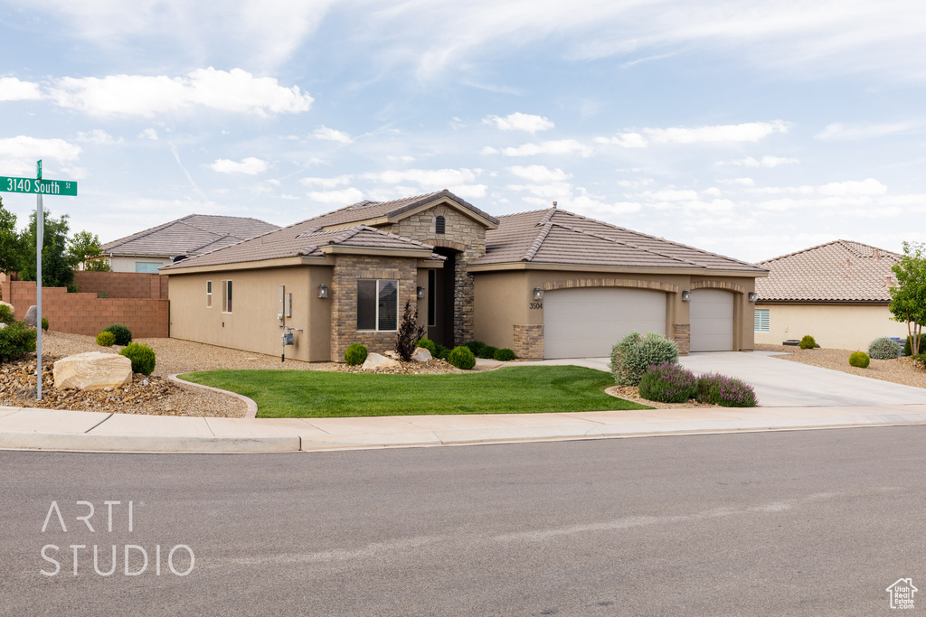 View of front facade featuring stone siding, stucco siding, driveway, an attached garage, and a tile roof