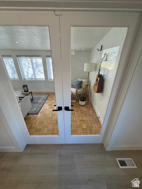 Bathroom featuring french doors and baseboards