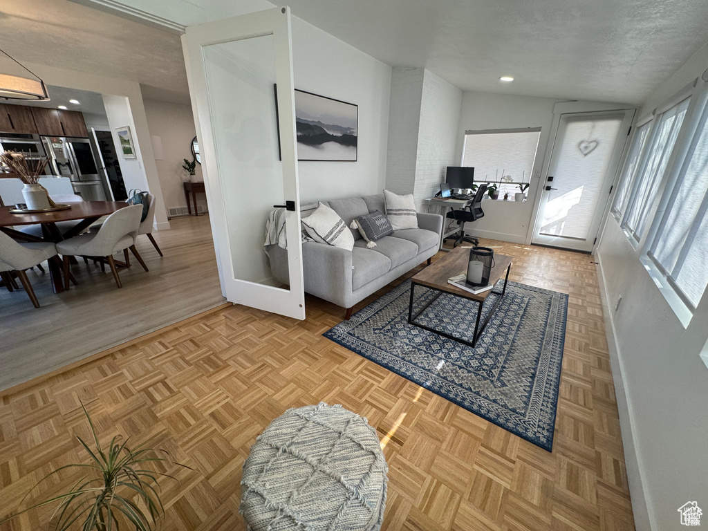 Living room featuring baseboards and recessed lighting