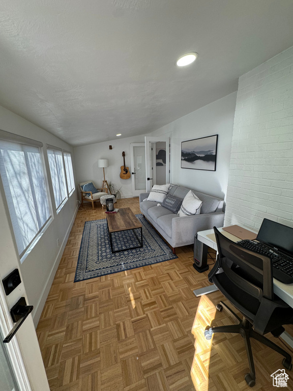 Living area with vaulted ceiling, baseboards, a desk, and recessed lighting