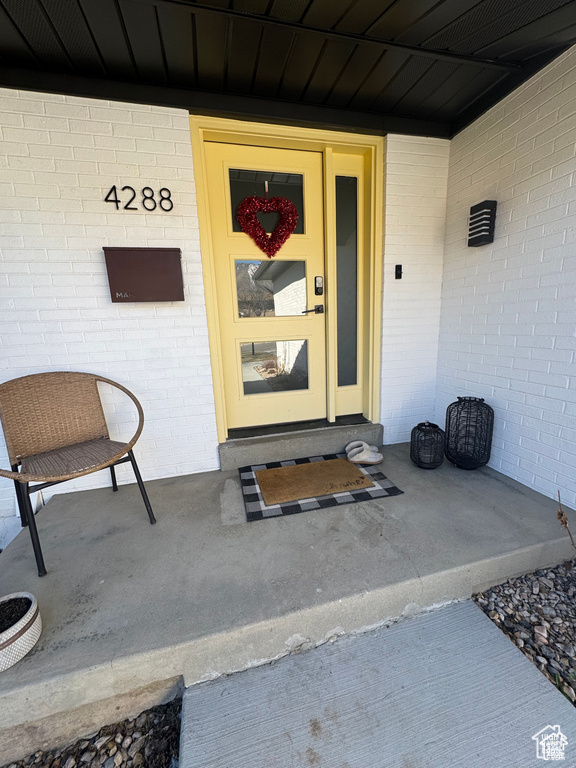 Property entrance featuring brick siding