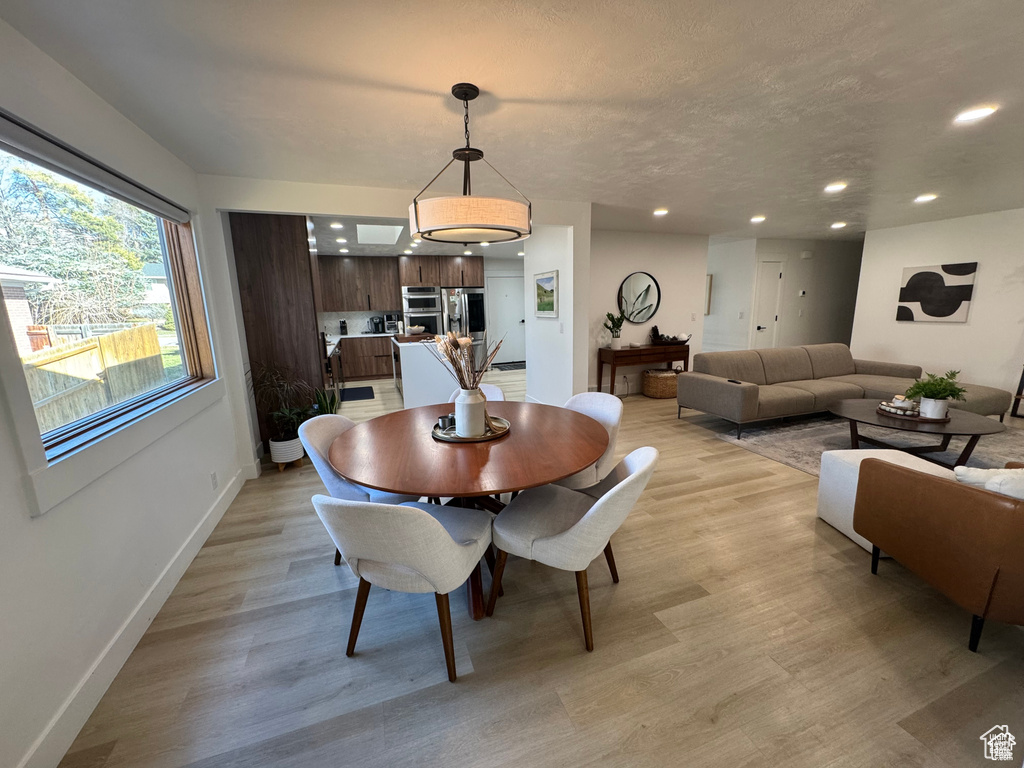Dining room featuring recessed lighting, light wood-style flooring, and baseboards