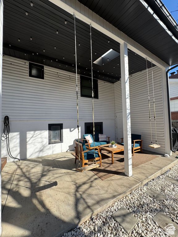 View of patio with outdoor lounge area and ceiling fan