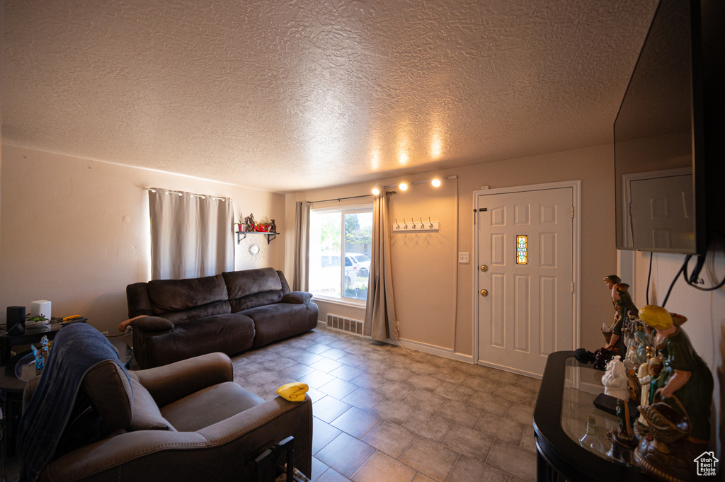 Living area featuring a textured ceiling
