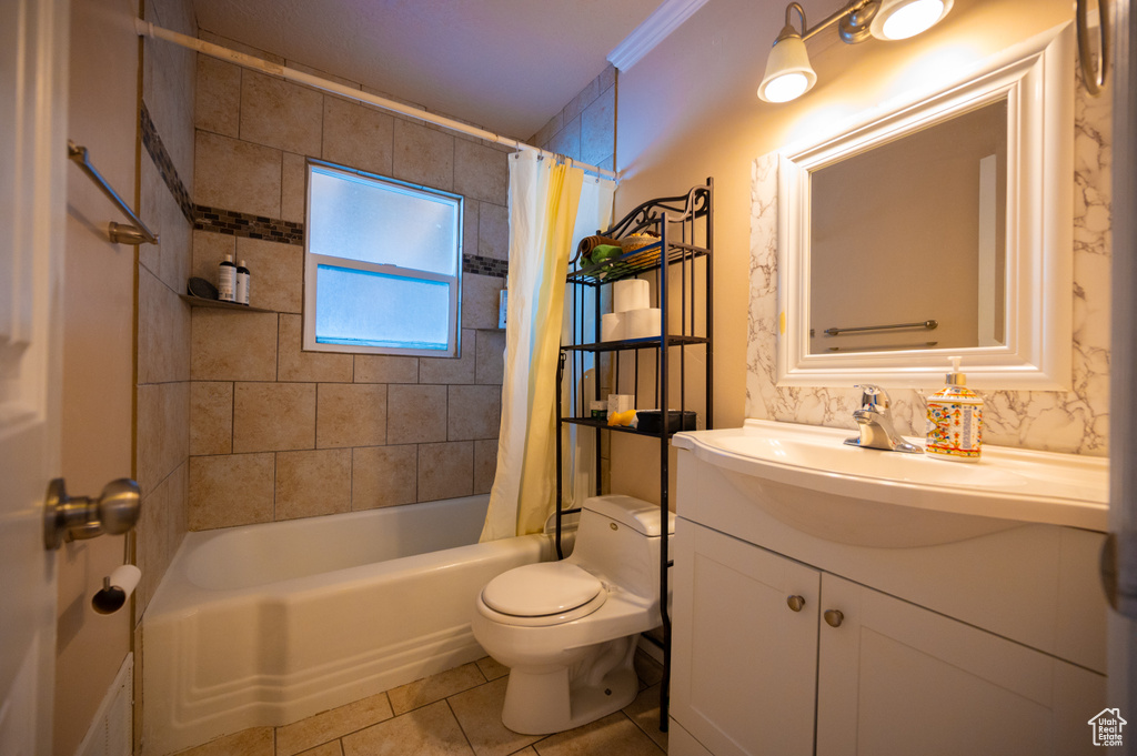 Full bath featuring toilet, vanity, shower / bath combo, and tile patterned flooring