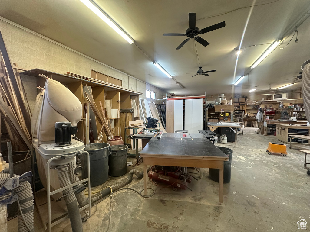 Garage featuring ceiling fan and a workshop area