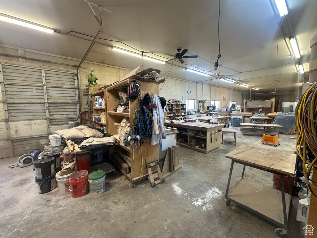 Garage with a workshop area and a ceiling fan