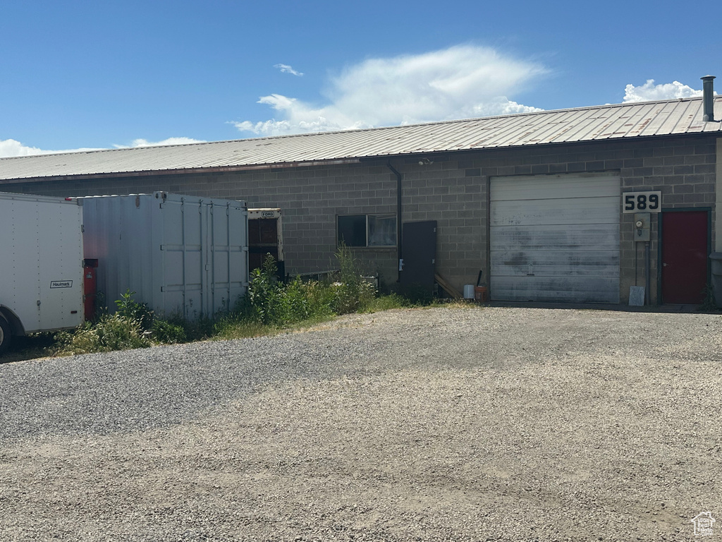 Garage featuring gravel driveway