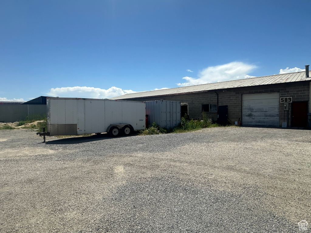 View of outbuilding with an attached garage and driveway
