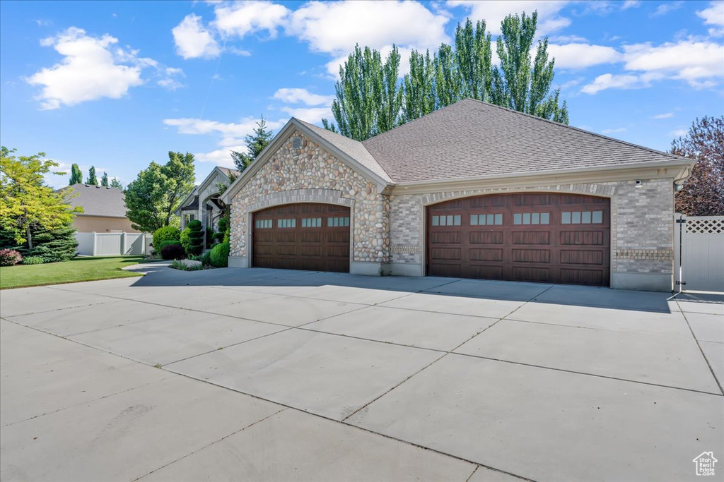 French provincial home with brick siding, concrete driveway, and a garage