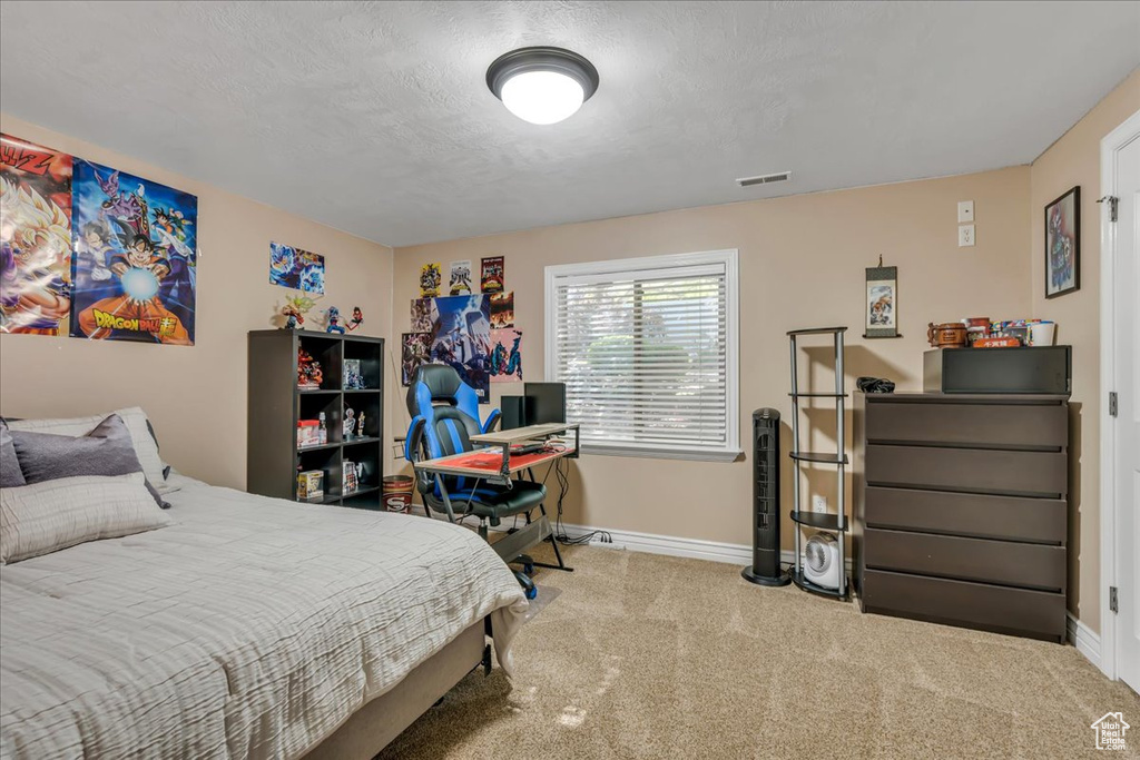 Bedroom with baseboards and carpet