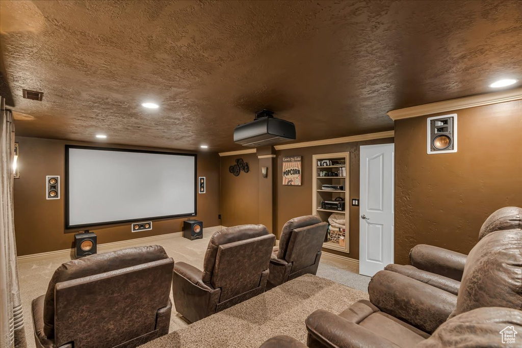Carpeted home theater featuring recessed lighting, baseboards, built in shelves, and a textured ceiling