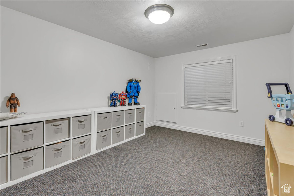 Office space with dark colored carpet and baseboards