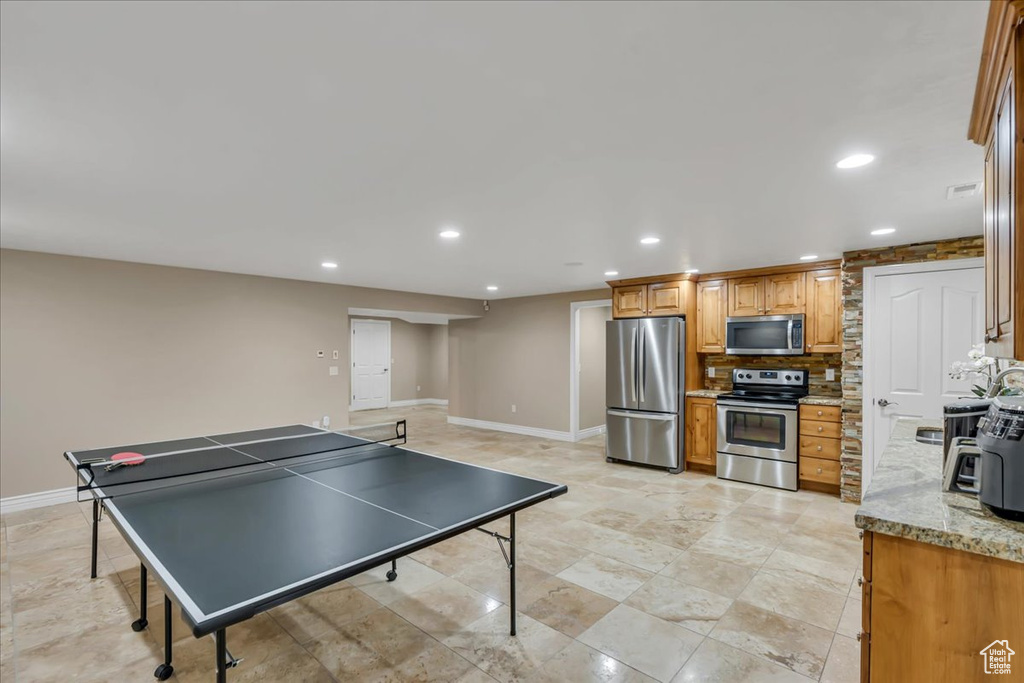 Recreation room featuring baseboards and recessed lighting