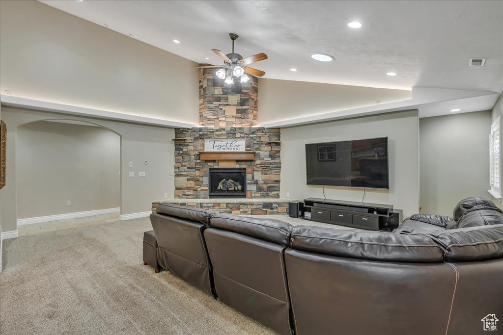 Living area with ceiling fan, lofted ceiling, arched walkways, a fireplace, and recessed lighting