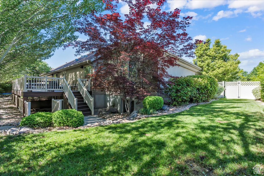 View of yard featuring stairs and a wooden deck